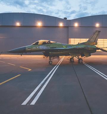 Plane parked in front of hangars