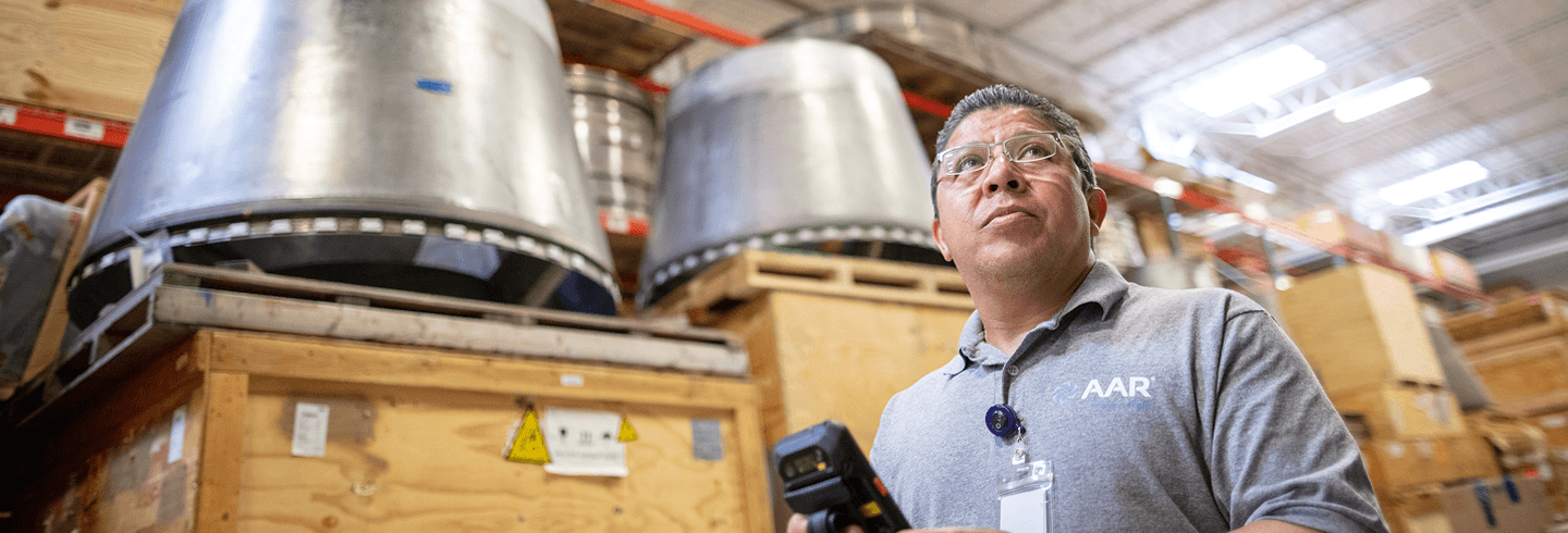 Emplyee standing in a parts warehouse
