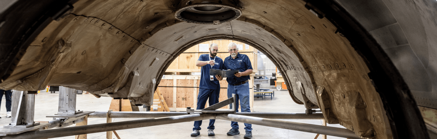 Mechanics repairing an airplane